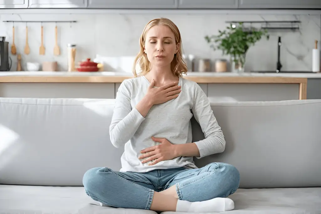 Woman practices mindful deep breathing.