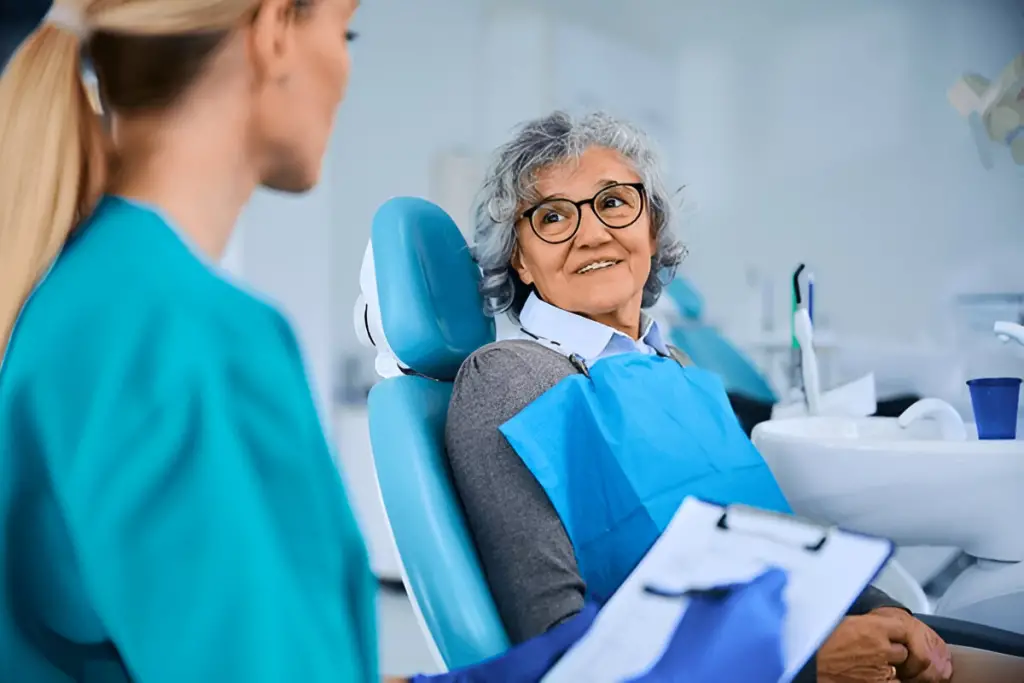 Senior woman talks to dentist.
