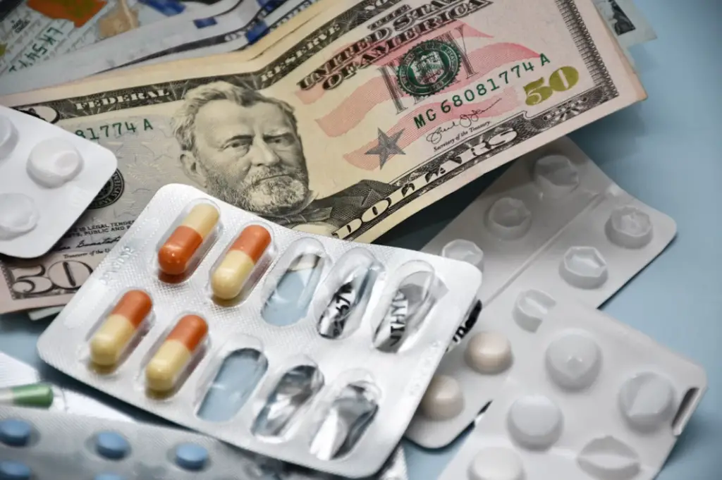 Medicine and money on table - Medicaid Help with Prescription Drug Costs