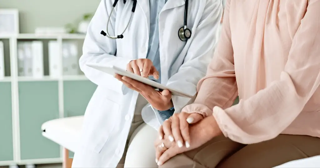 Doctor reviews tablet with patient.