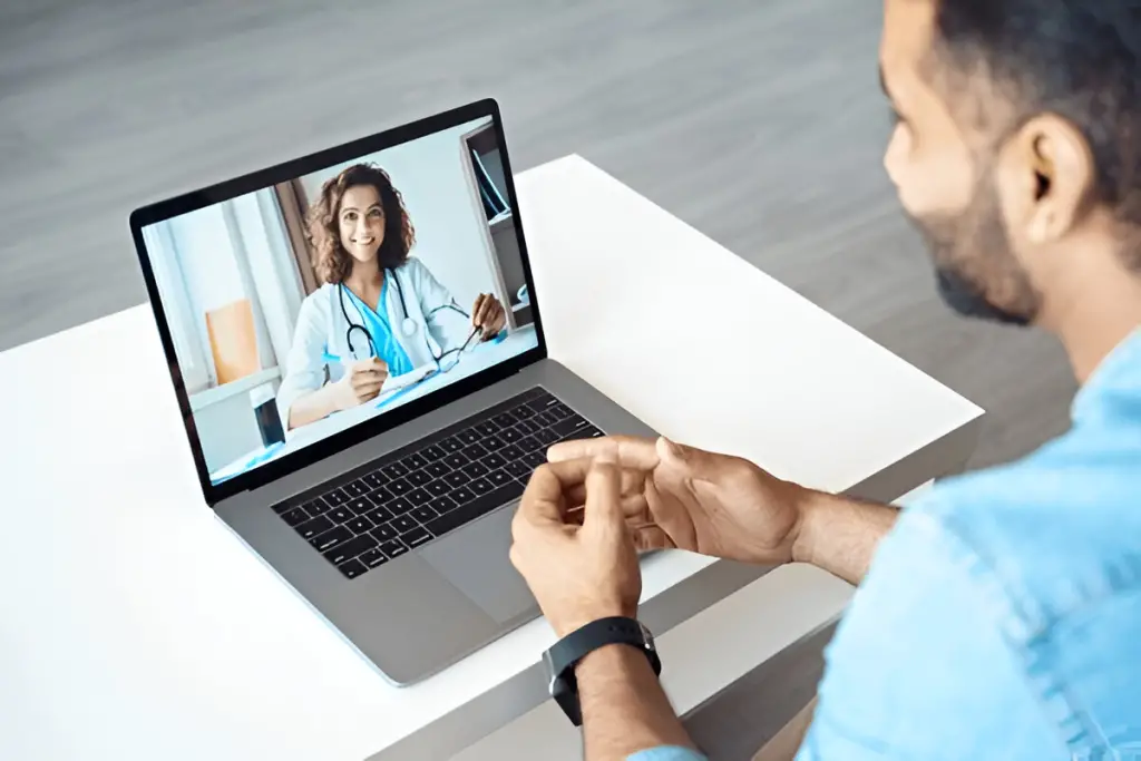 Man on telehealth call with doctor.