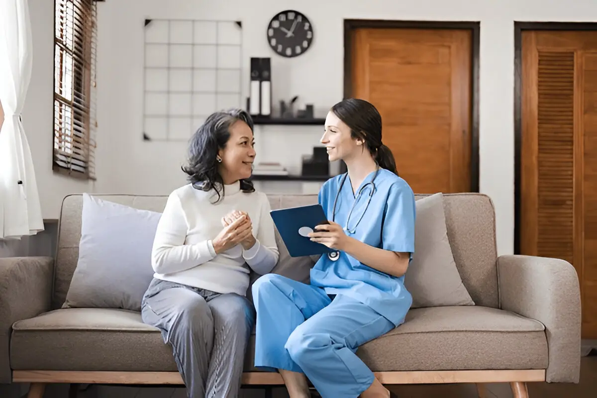 Older woman and nurse talking.