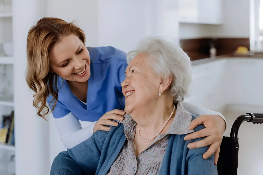 Nurse comforting older woman smiling.