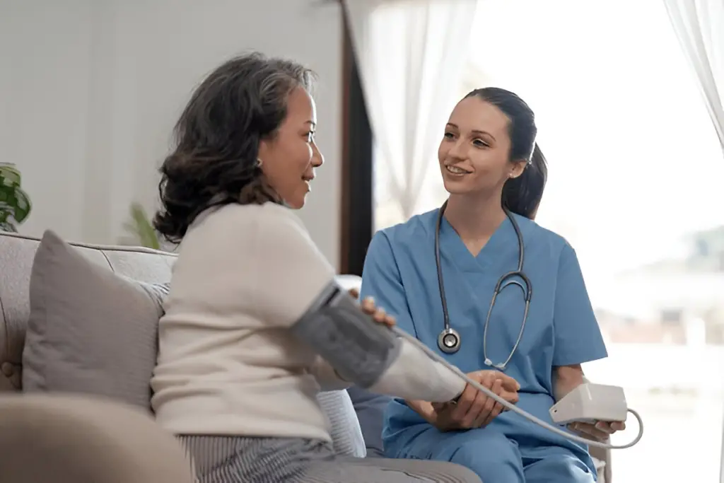 Nurse checking patient's blood pressure.