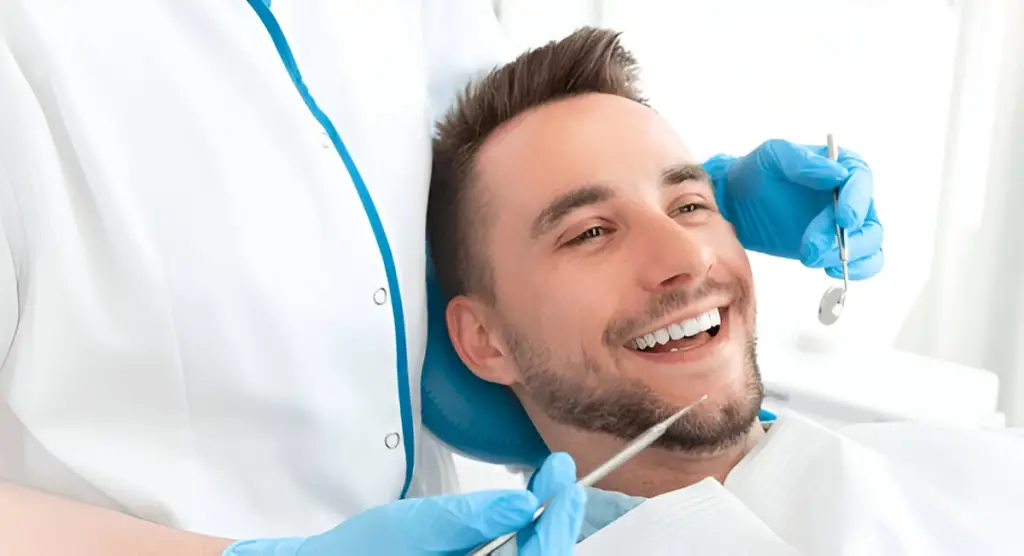 Man smiling in dental chair.