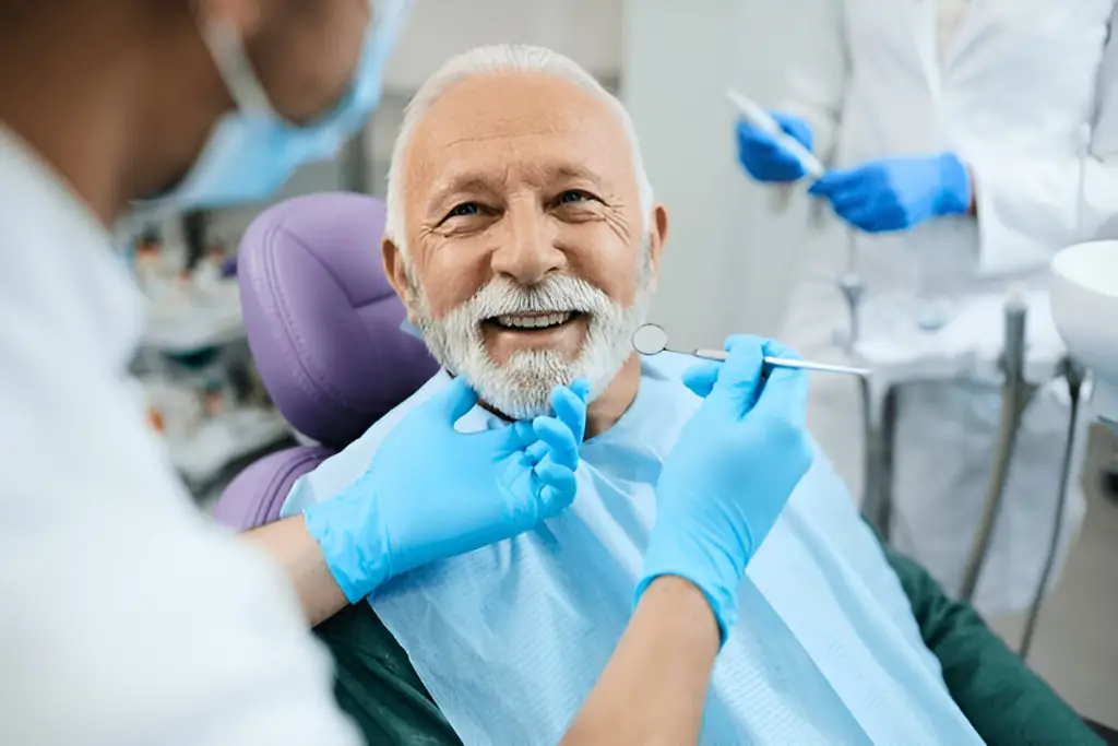Smiling elderly man at dentist.
