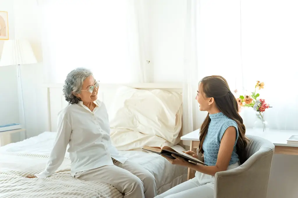 Daughter reading to elderly mother.