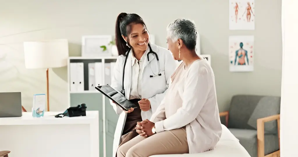 Doctor showing patient medical tablet.