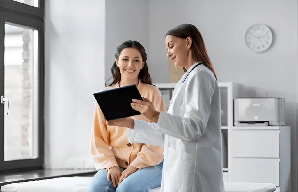 Doctor showing patient results on tablet.