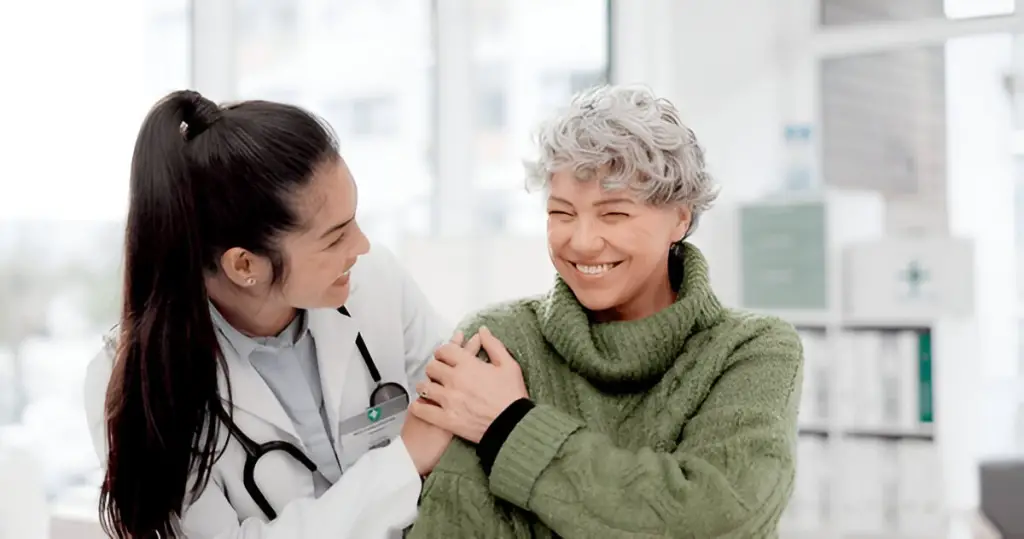 Doctor reassuring happy elderly patient.