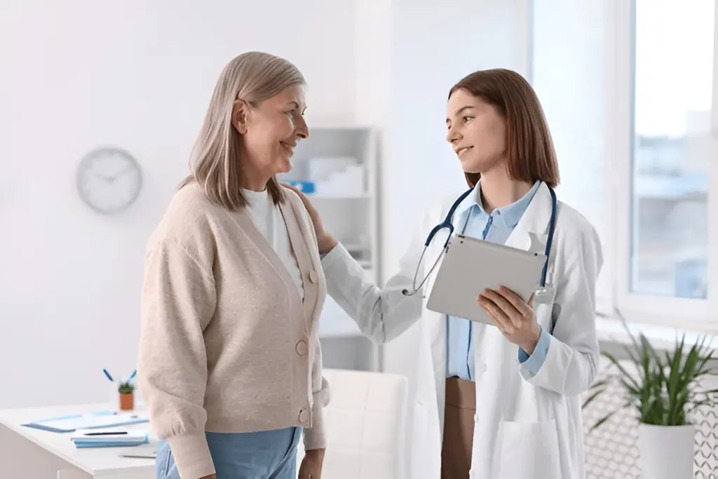 Doctor reassuring older woman patient.