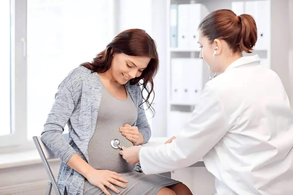 Doctor listens to pregnant belly.