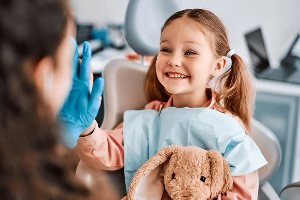Happy child gives dentist high five