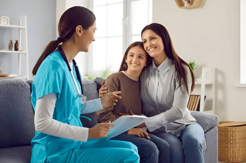 Doctor consults with mother and smiling daughter
