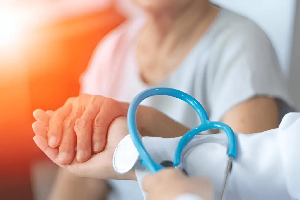 Doctor taking older patient's pulse.