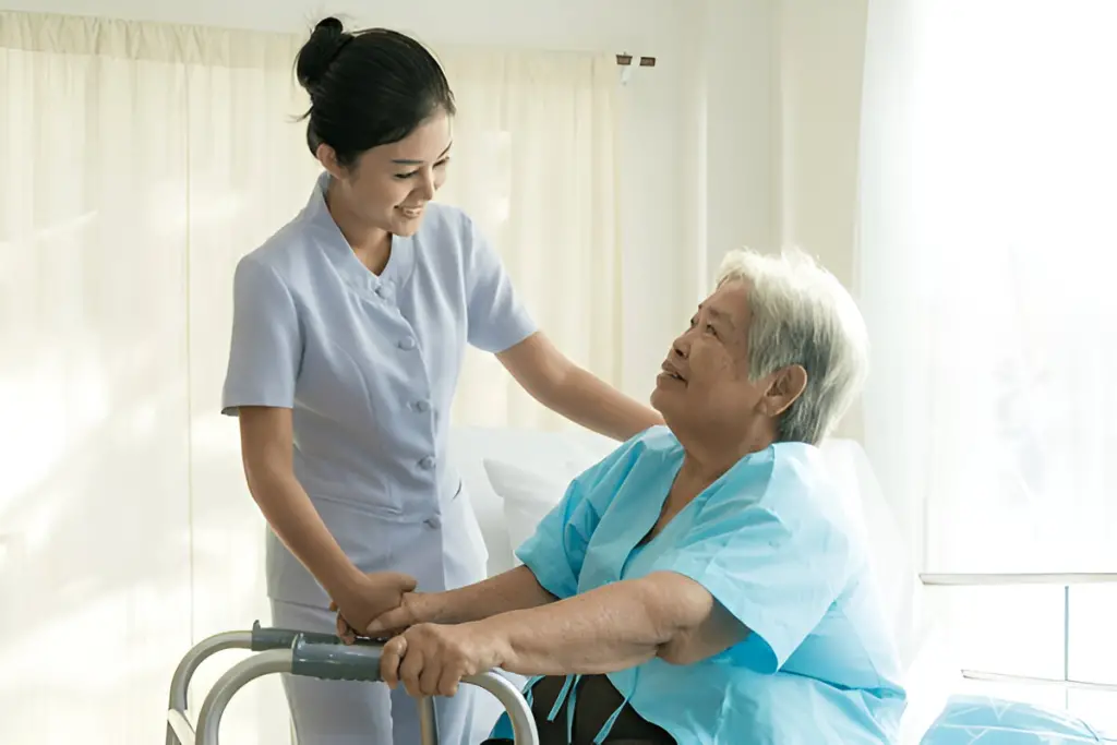Nurse helps elderly patient with walker.