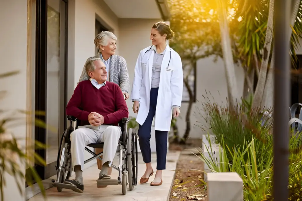 Doctor and couple outdoors with wheelchair.