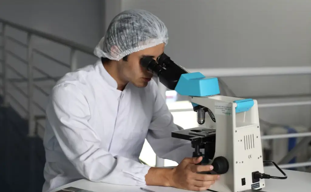 Scientist using a laboratory microscope.
