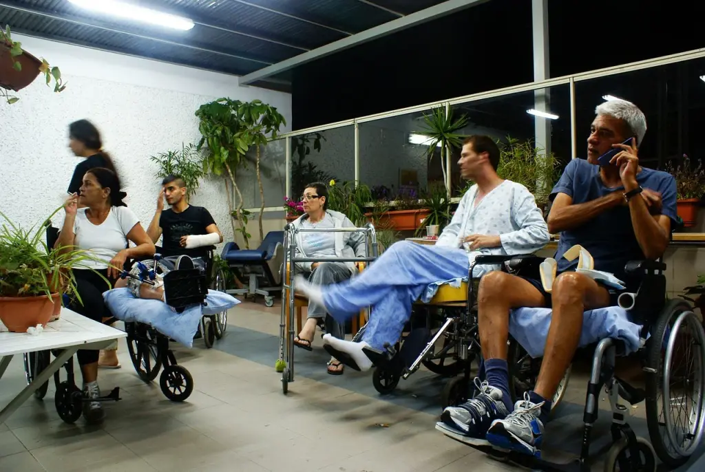 Patients sitting in wheelchairs outside.