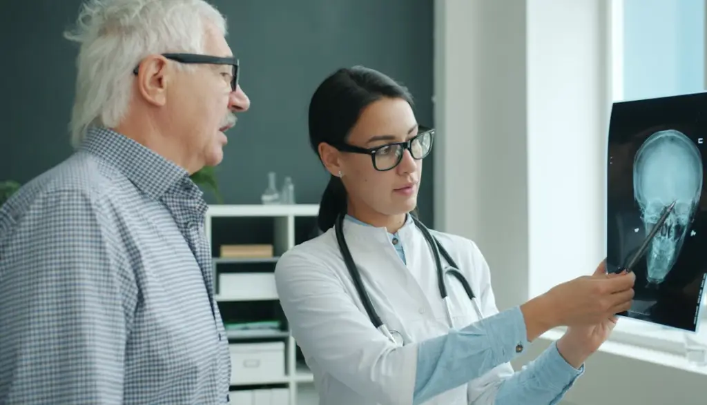 Doctor showing senior man X-ray.