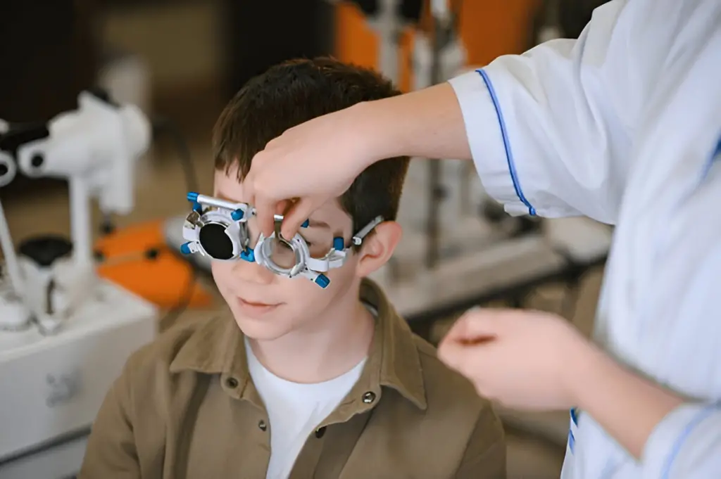 Optometrist testing boy's vision.