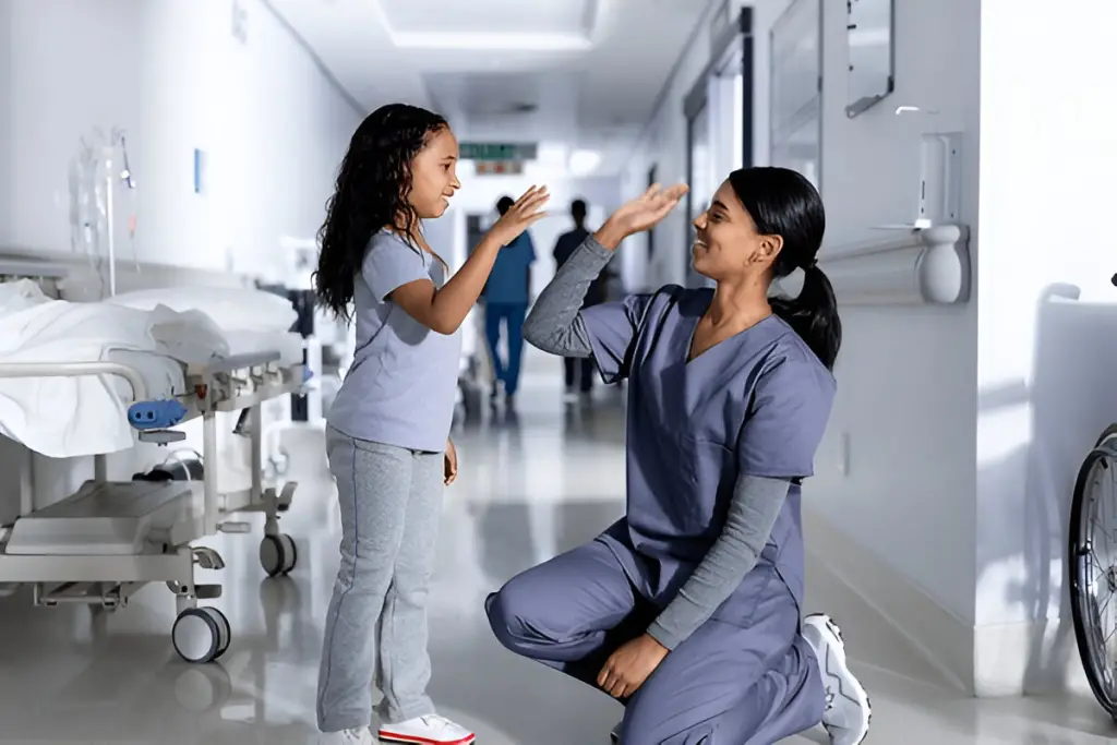 Nurse high-fiving young patient.