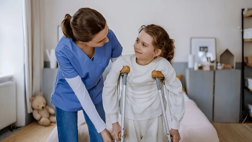 Caregiver helping child with crutches.