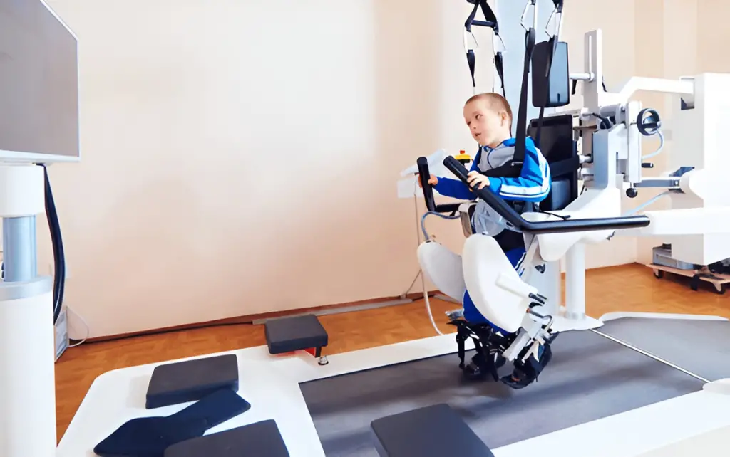 Child using robotic therapy device.