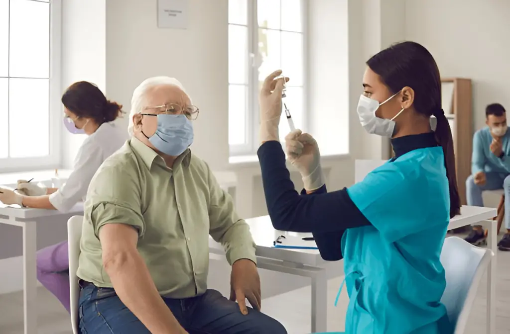 Nurse preparing vaccine for senior man.