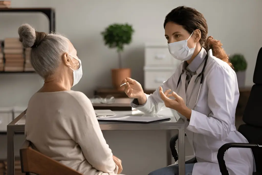 Doctor and patient wearing face masks.
